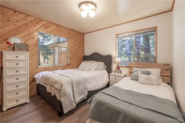a bedroom with a bed a window and closet