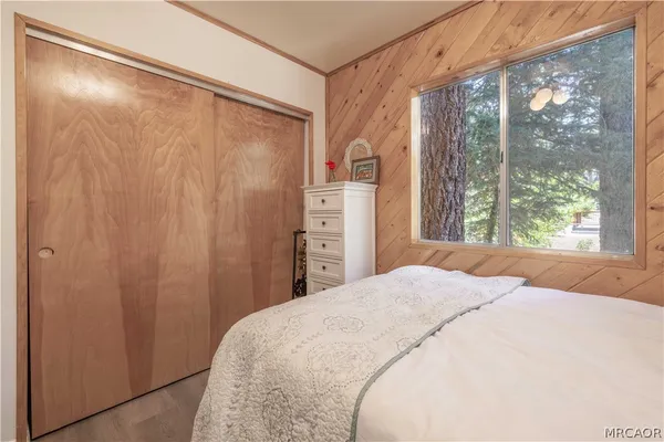 a bedroom with a bed and a large window