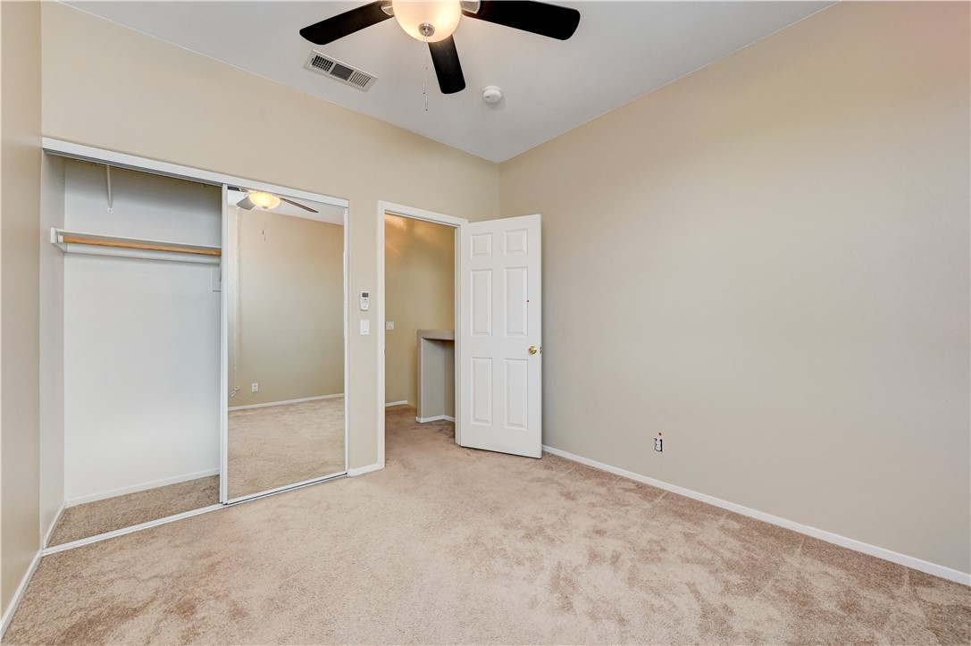 2232 Ramsgate Drive Henderson, NV 89074 - Photo 18 of 19 A quiet bedroom features neutral walls and plush wall-to-wall carpeting.