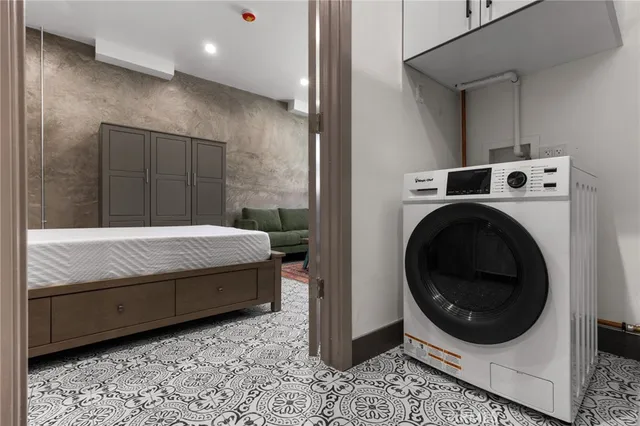 a bathroom with a granite countertop sink a toilet and a mirror