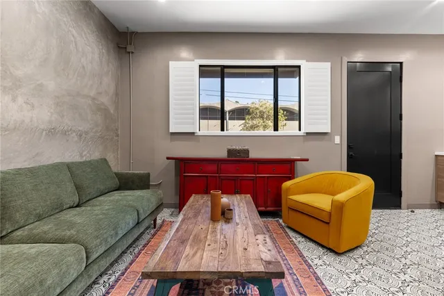 a living room with furniture a rug and a window