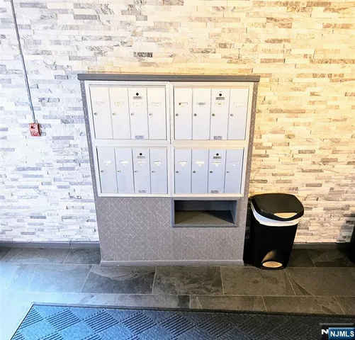 a view of entryway with granite countertop lots of wooden cabinets