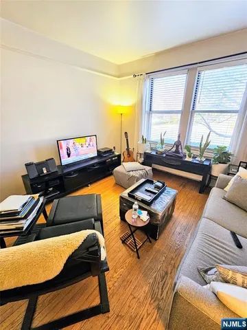 a living room with furniture and a floor to ceiling window