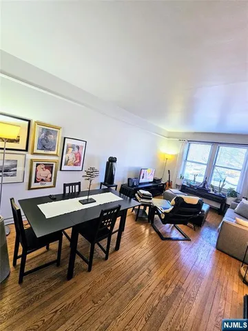 a living room with furniture pool table and a wooden floor