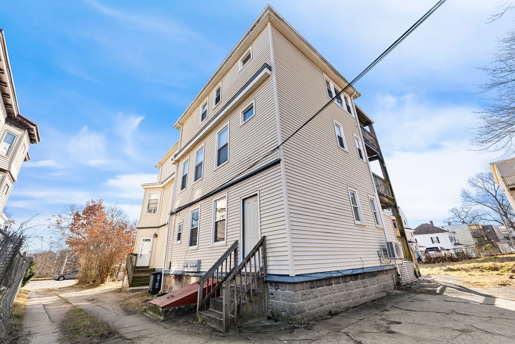 515 R Norfolk Street Boston, MA 02126 - Photo 23 of 26 a view of a house with a yard