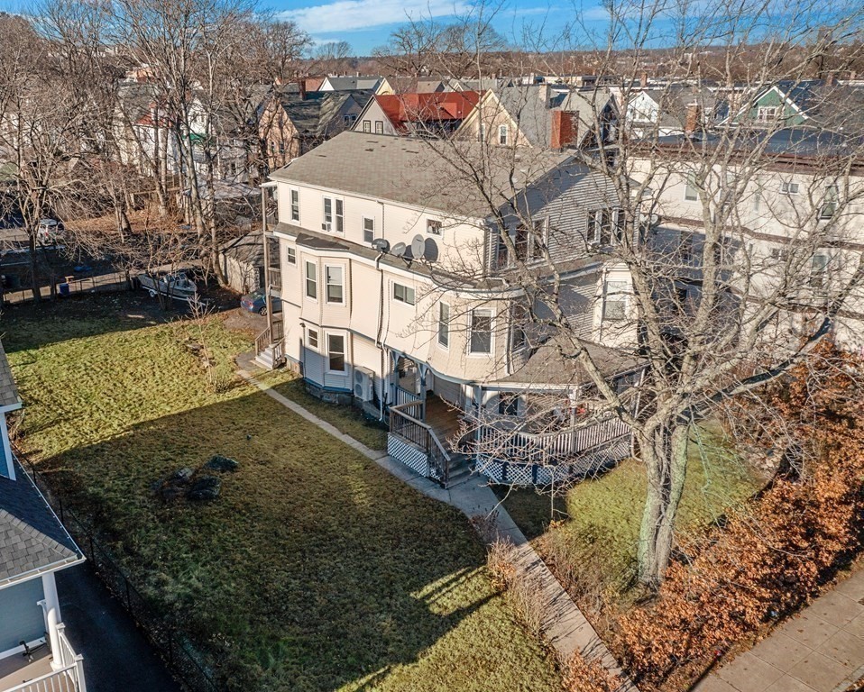 515 R Norfolk Street Boston, MA 02126 - Photo 3 of 26 a large building with a yard