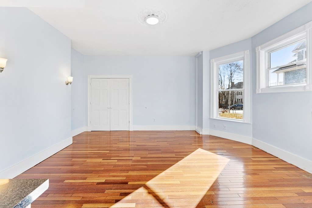 515 R Norfolk Street Boston, MA 02126 - Photo 8 of 26 a view of a room with wooden floor and white walls