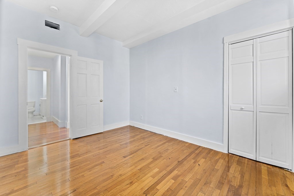 515 R Norfolk Street Boston, MA 02126 - Photo 9 of 26 a view of an empty room with wooden floor