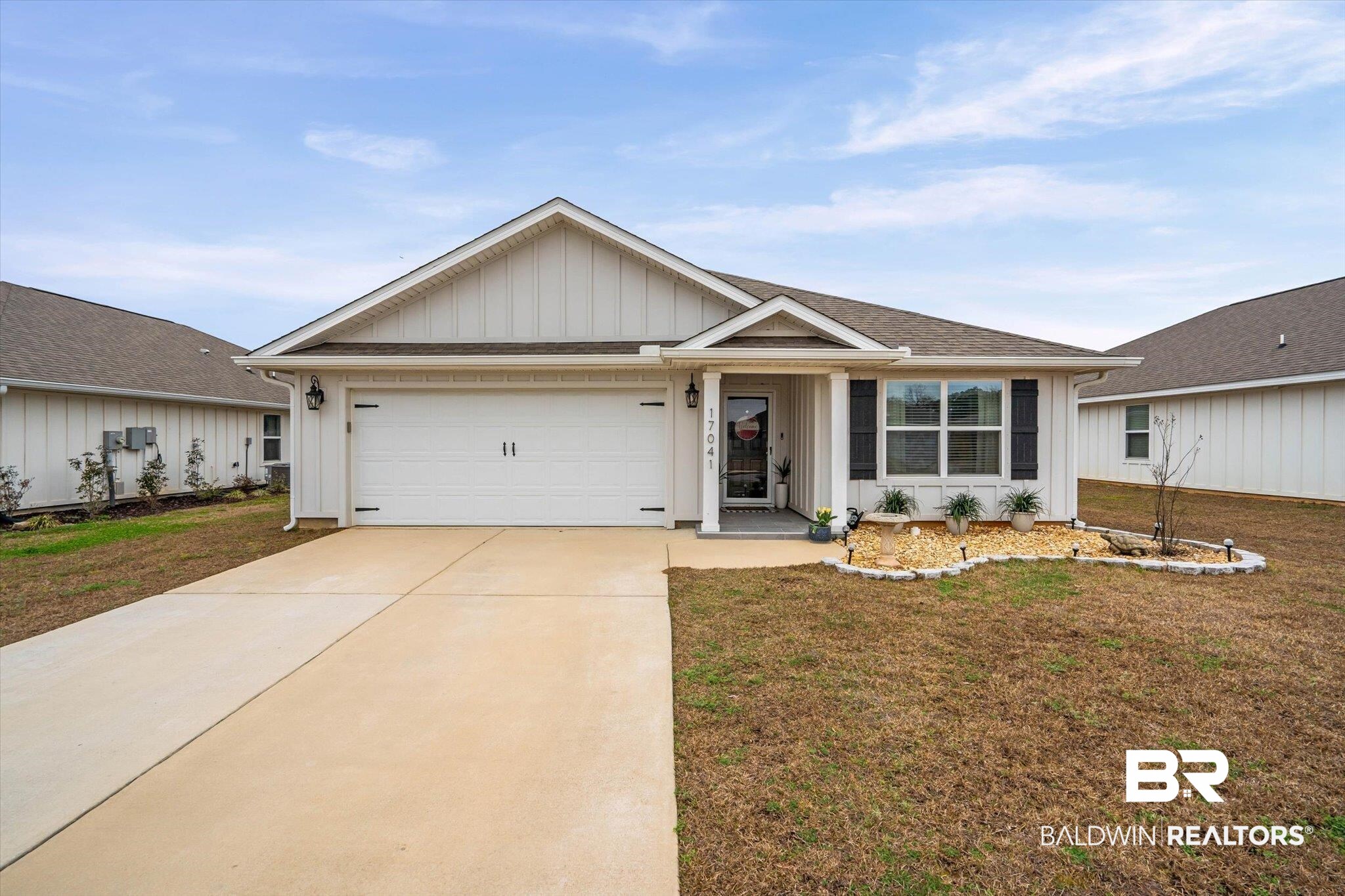 17041 Muse Street Loxley, AL 36551 - Photo 1 of 44 Single story home with board and batten siding, driveway, a front yard, an attached garage, and a shingled roof