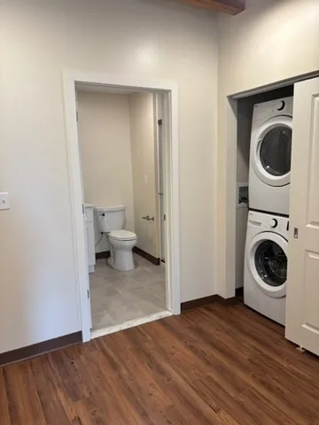 a view of a storage and utility room with wooden floor