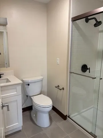 a white toilet sitting next to a bathroom sink