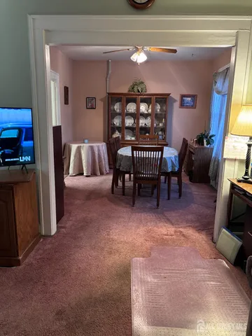a view of a livingroom with furniture and a window