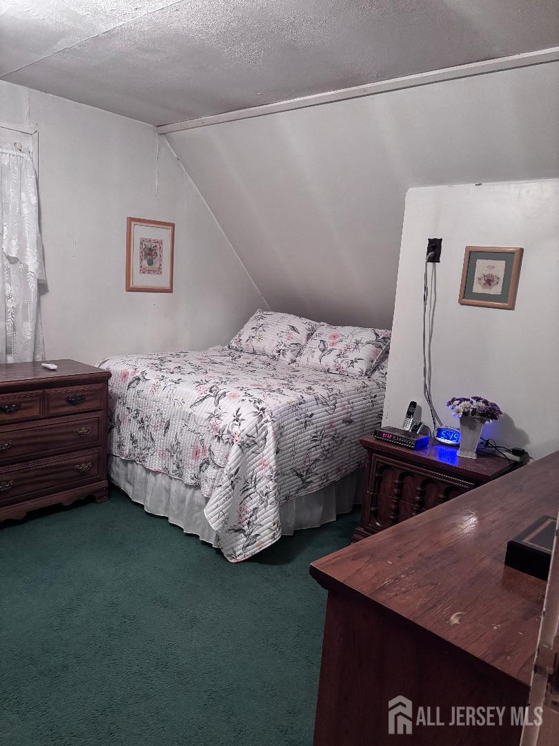 490 Mckeon Street Perth Amboy, NJ 08861 - Photo 17 of 28 a bedroom with a bed and a dresser