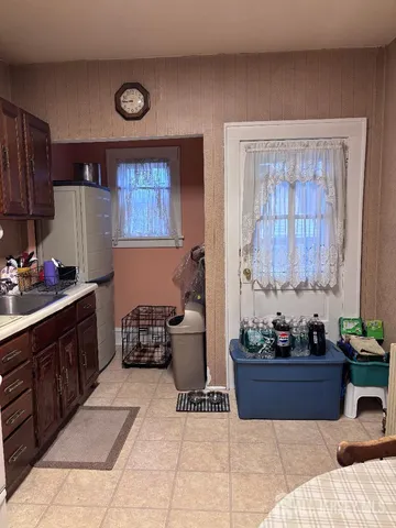 a kitchen with a refrigerator and a stove