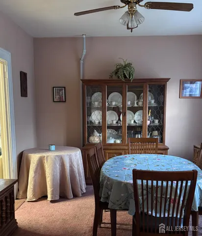 a bedroom with a balcony a bed and a table in it