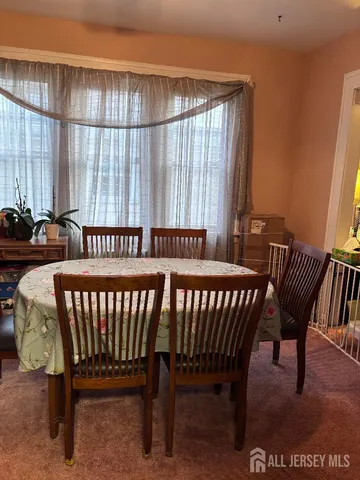 a view of a bedroom with furniture and a window