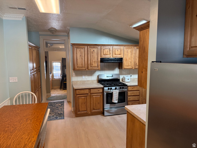 541 300 North Provo, UT 84606 - Photo 22 of 36 Kitchen featuring wood cabinetry, stainless steel gas range, light-toned countertops, and wood-finish flooring