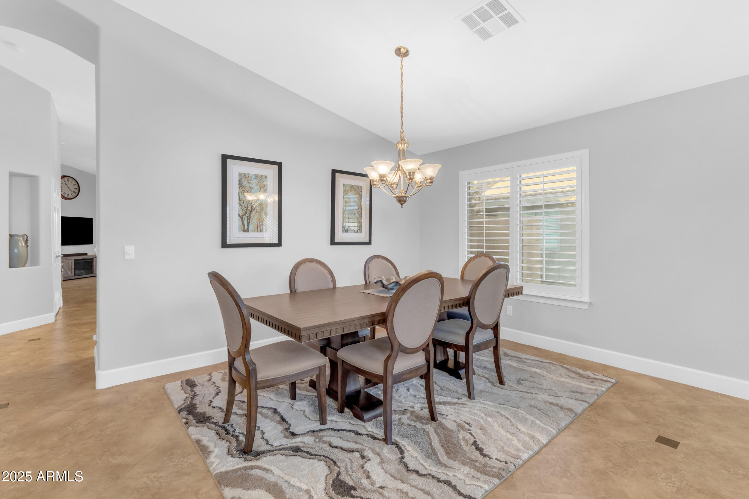 13438 West Redfield Road Surprise, AZ 85379 - Photo 12 of 75 a view of a dining room with furniture window and wooden floor