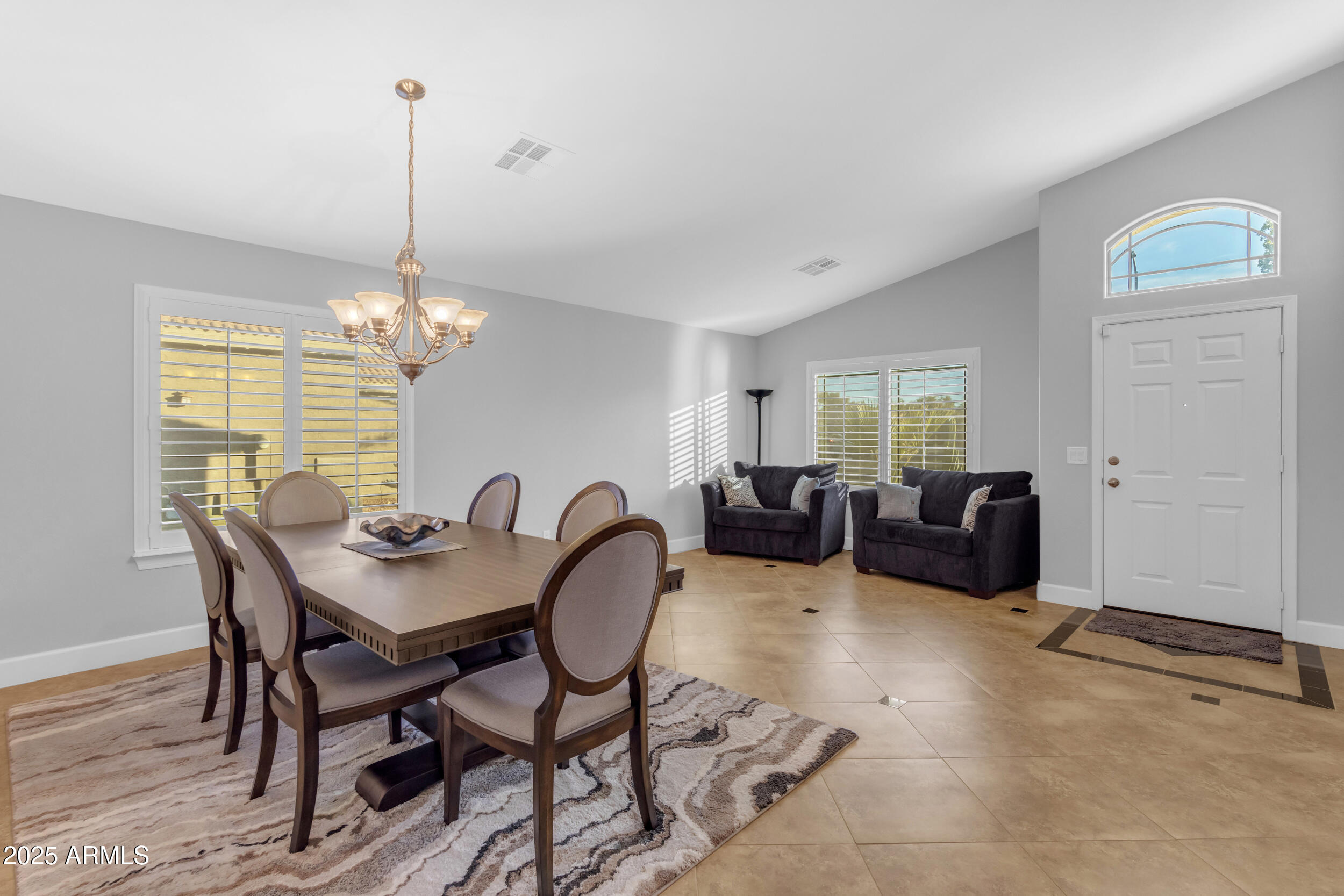 13438 West Redfield Road Surprise, AZ 85379 - Photo 16 of 75 a view of a dining room with furniture a chandelier and wooden floor