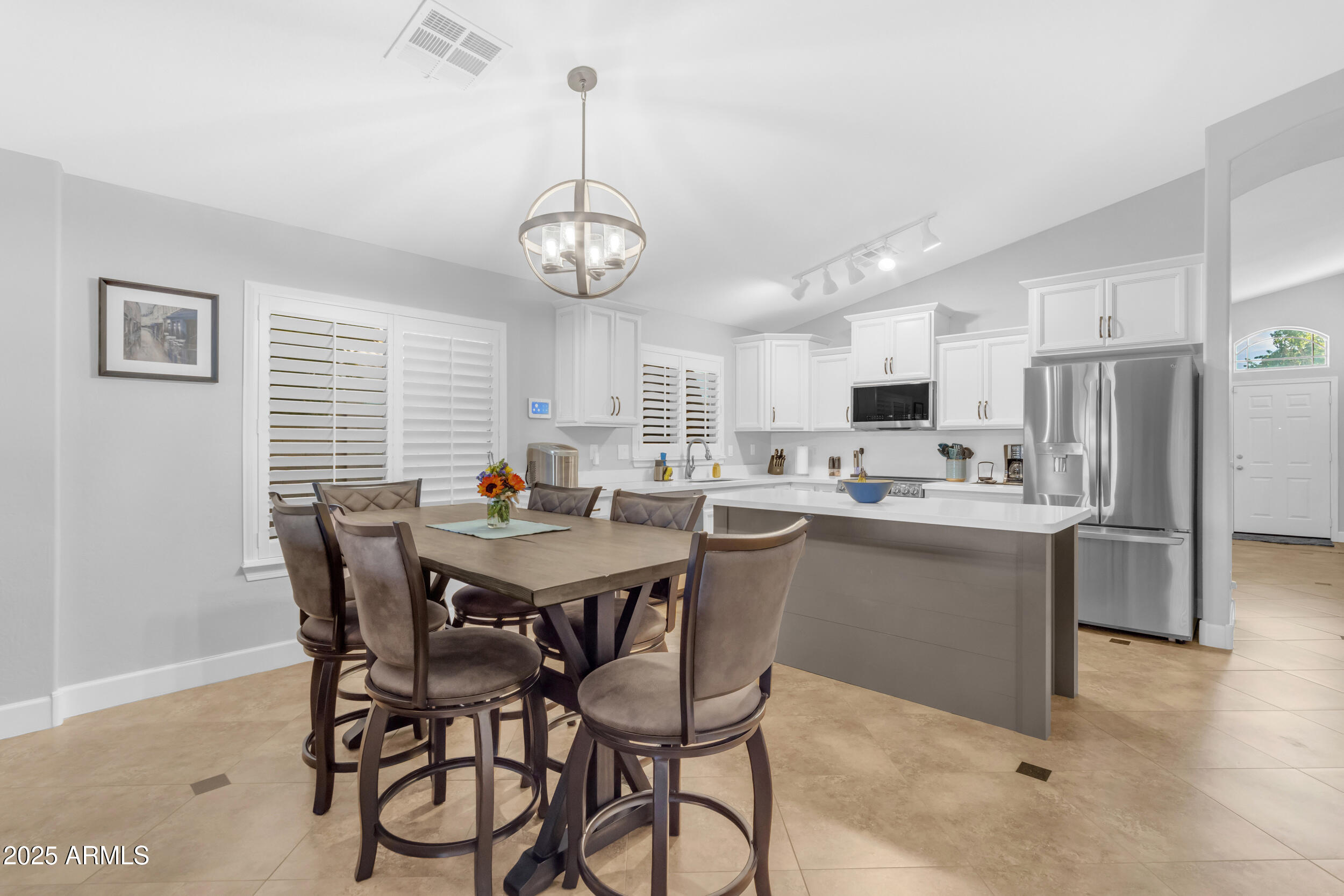 13438 West Redfield Road Surprise, AZ 85379 - Photo 28 of 75 a view of a dining room with furniture a chandelier and kitchen view