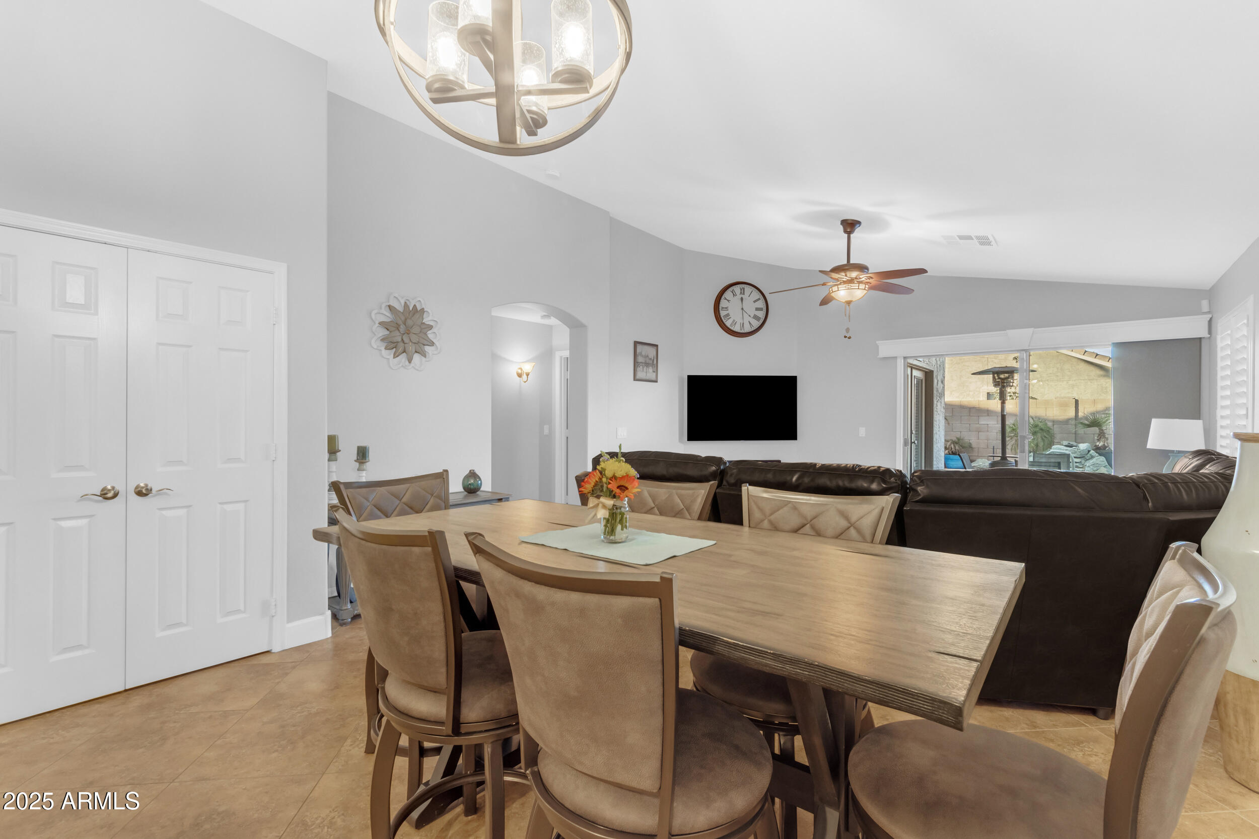 13438 West Redfield Road Surprise, AZ 85379 - Photo 30 of 75 a view of a dining room with furniture and a chandelier