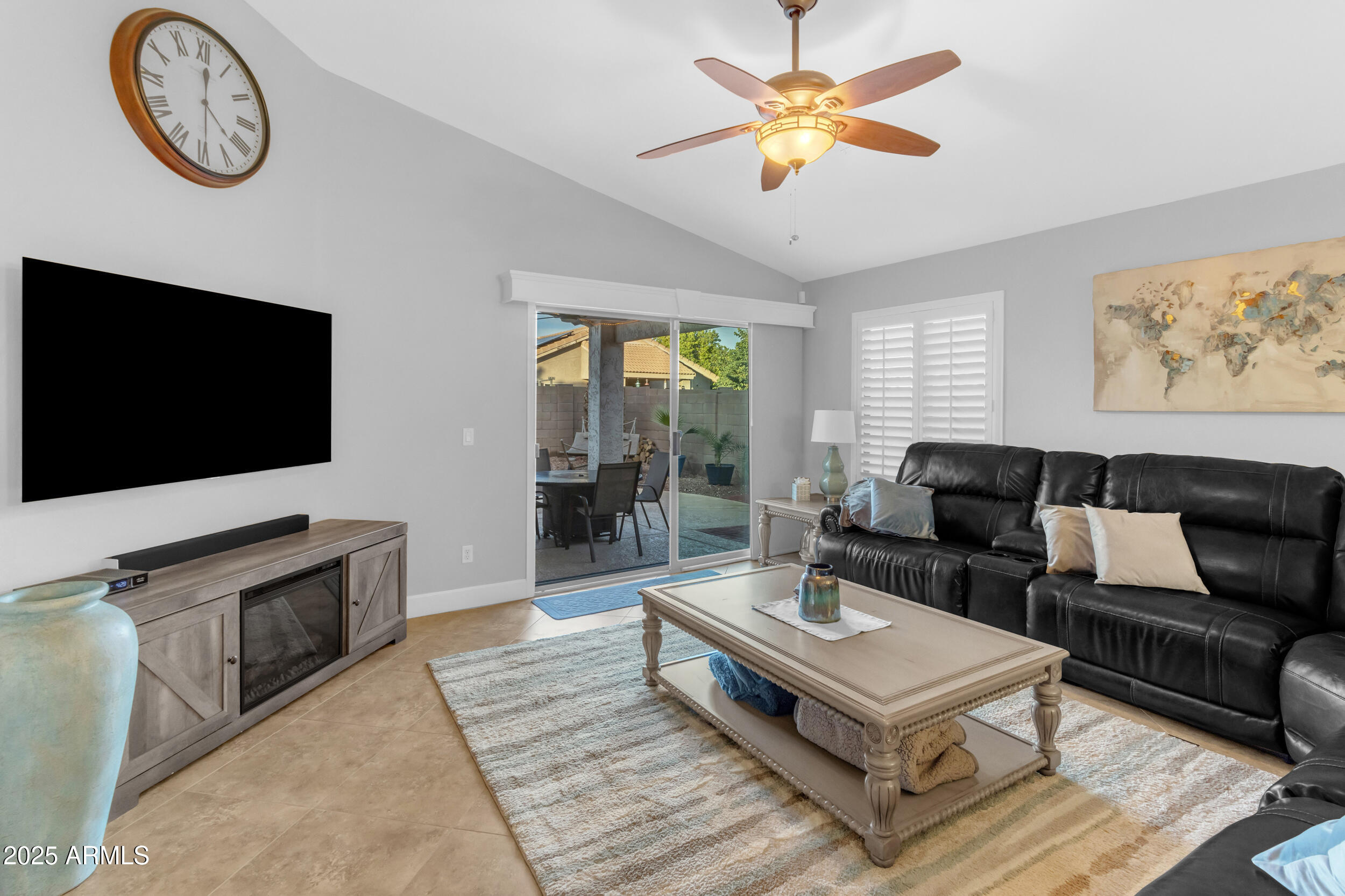 13438 West Redfield Road Surprise, AZ 85379 - Photo 32 of 75 a living room with furniture a flat screen tv and a fireplace