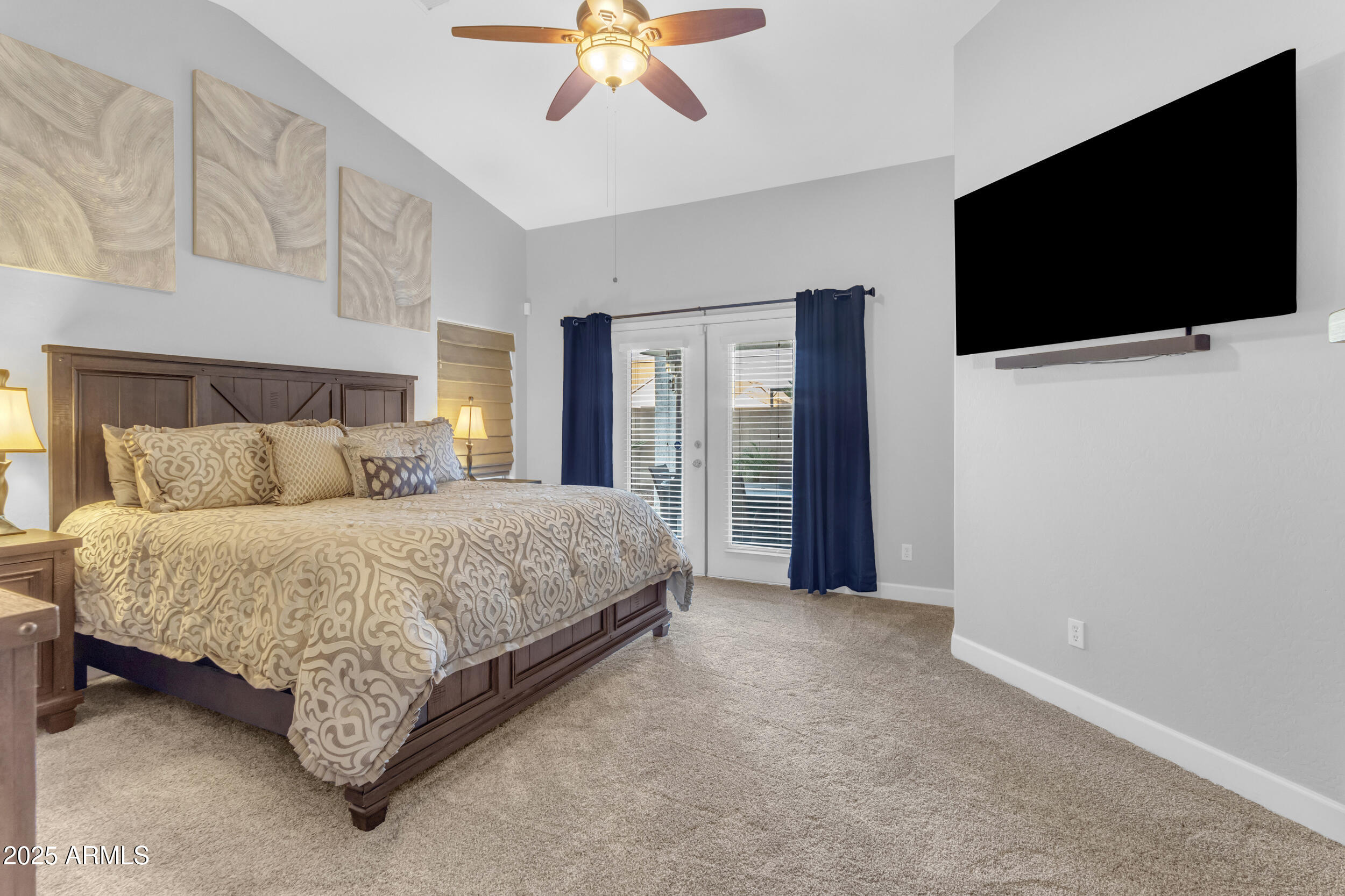 13438 West Redfield Road Surprise, AZ 85379 - Photo 41 of 75 a spacious bedroom with a bed and a flat screen tv