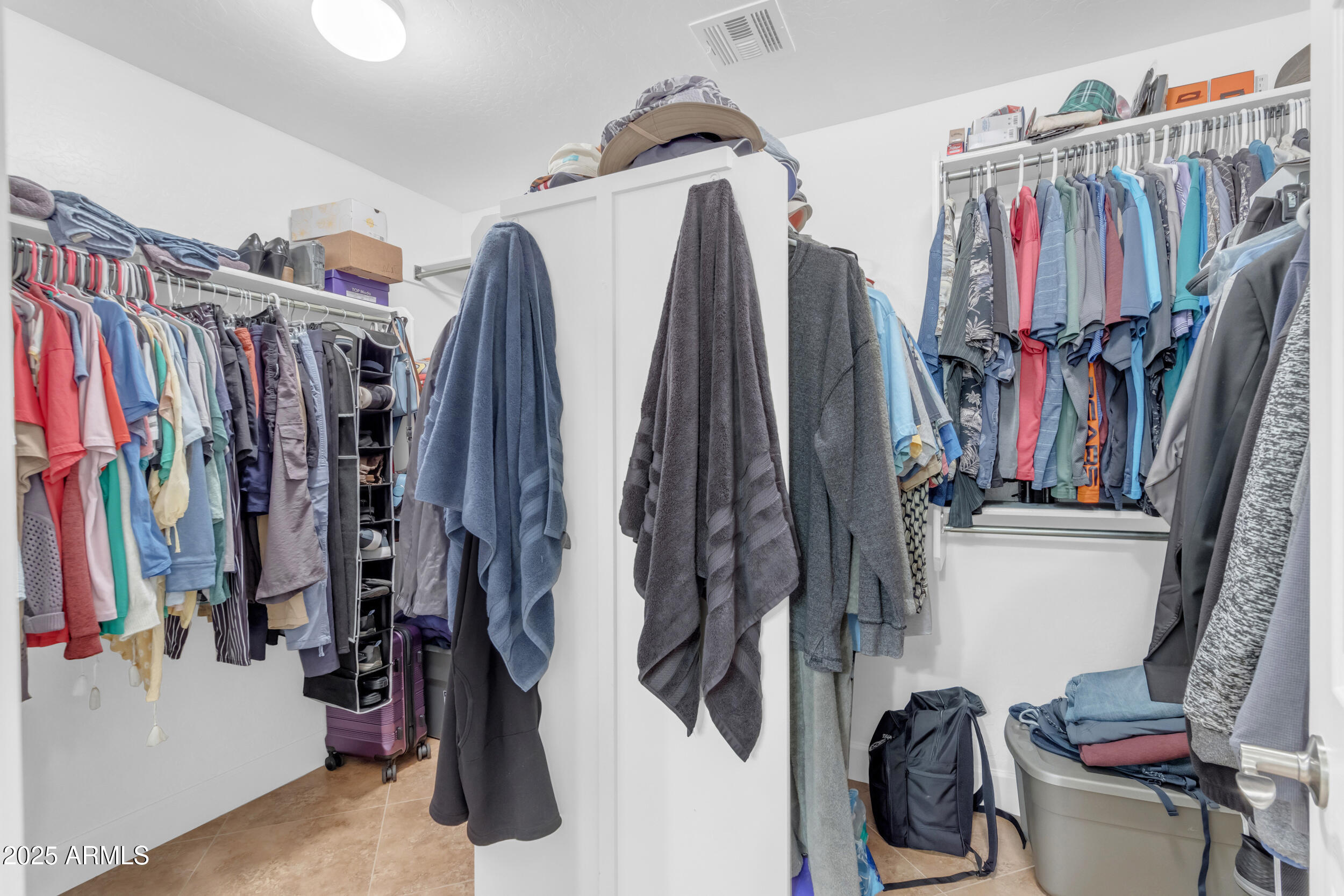 13438 West Redfield Road Surprise, AZ 85379 - Photo 44 of 75 a view of walk in closet with clothes and shoes