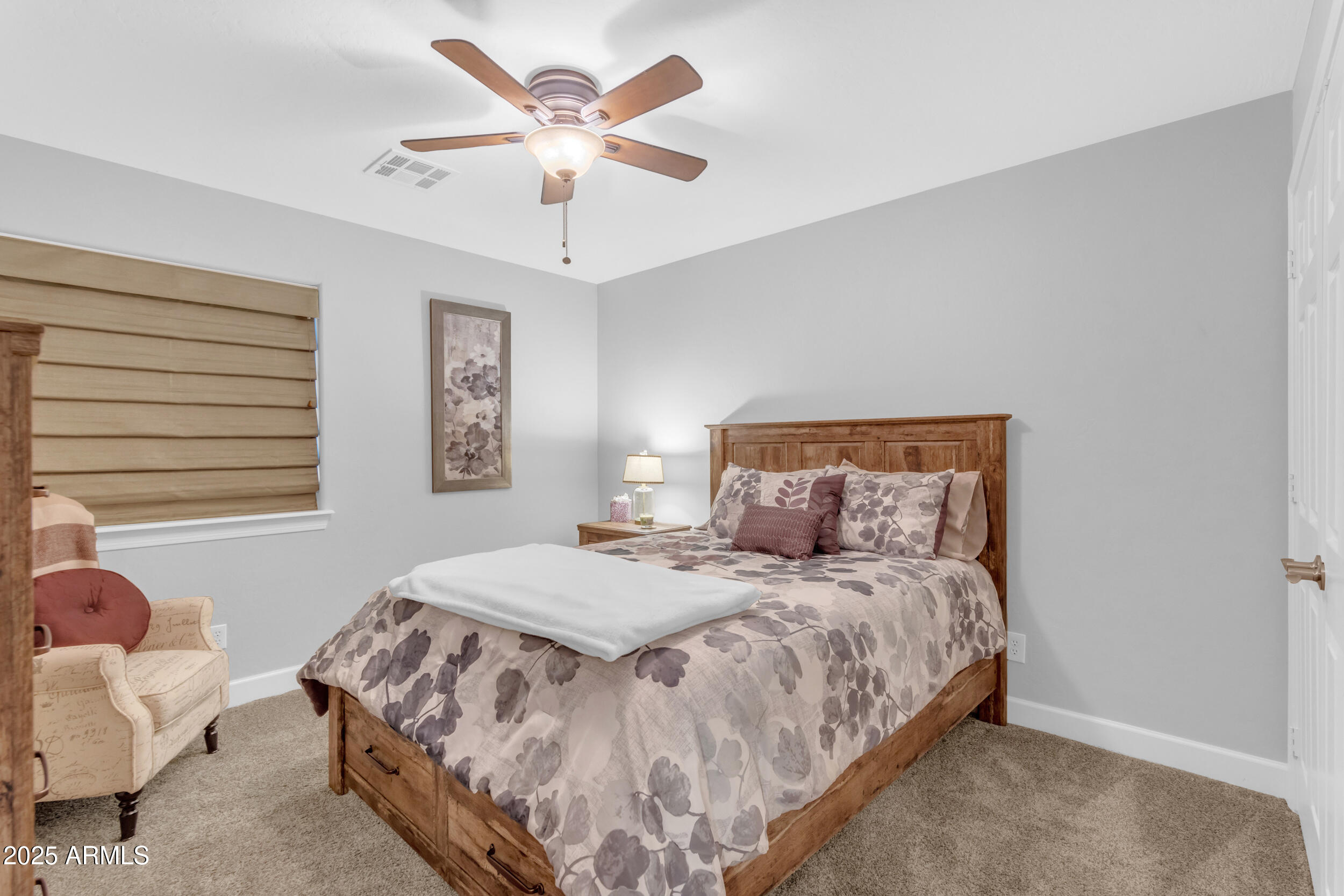 13438 West Redfield Road Surprise, AZ 85379 - Photo 51 of 75 a bedroom with a bed and a chandelier