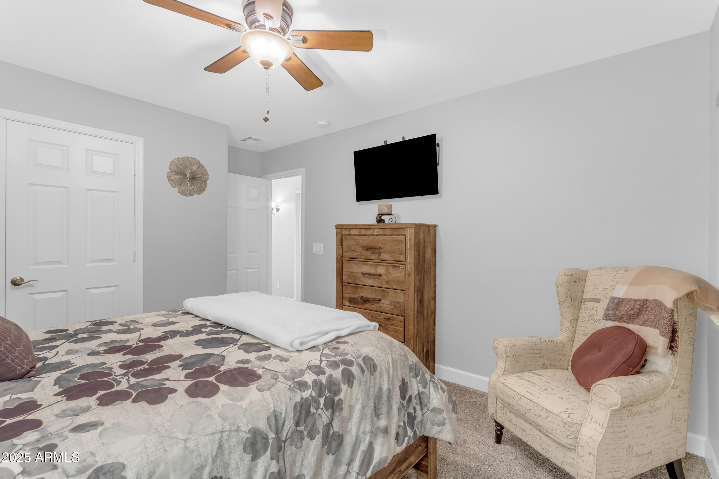 13438 West Redfield Road Surprise, AZ 85379 - Photo 52 of 75 a bedroom with a bed and a flat screen tv