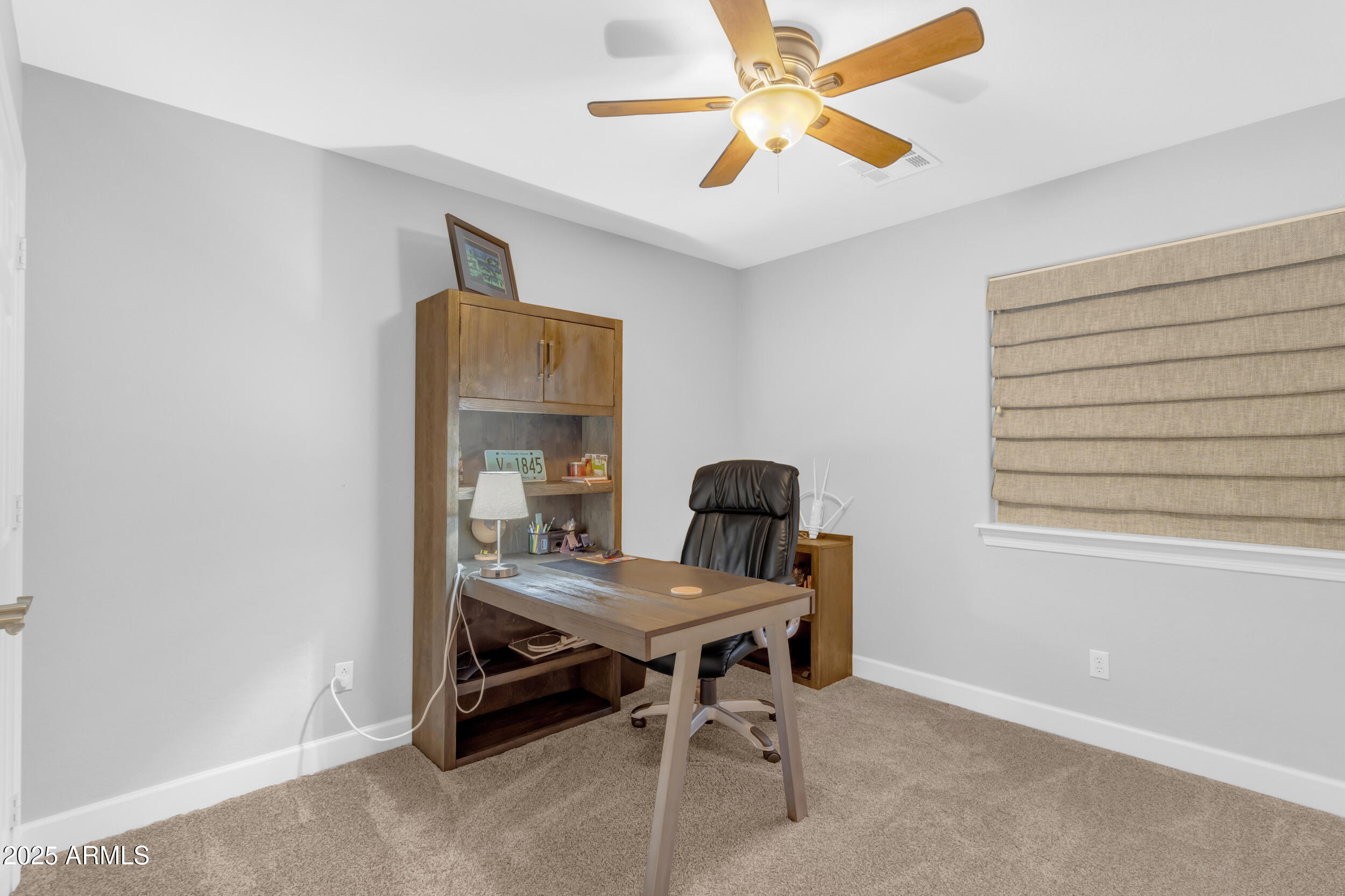 13438 West Redfield Road Surprise, AZ 85379 - Photo 54 of 75 a view of a workspace with furniture and a window