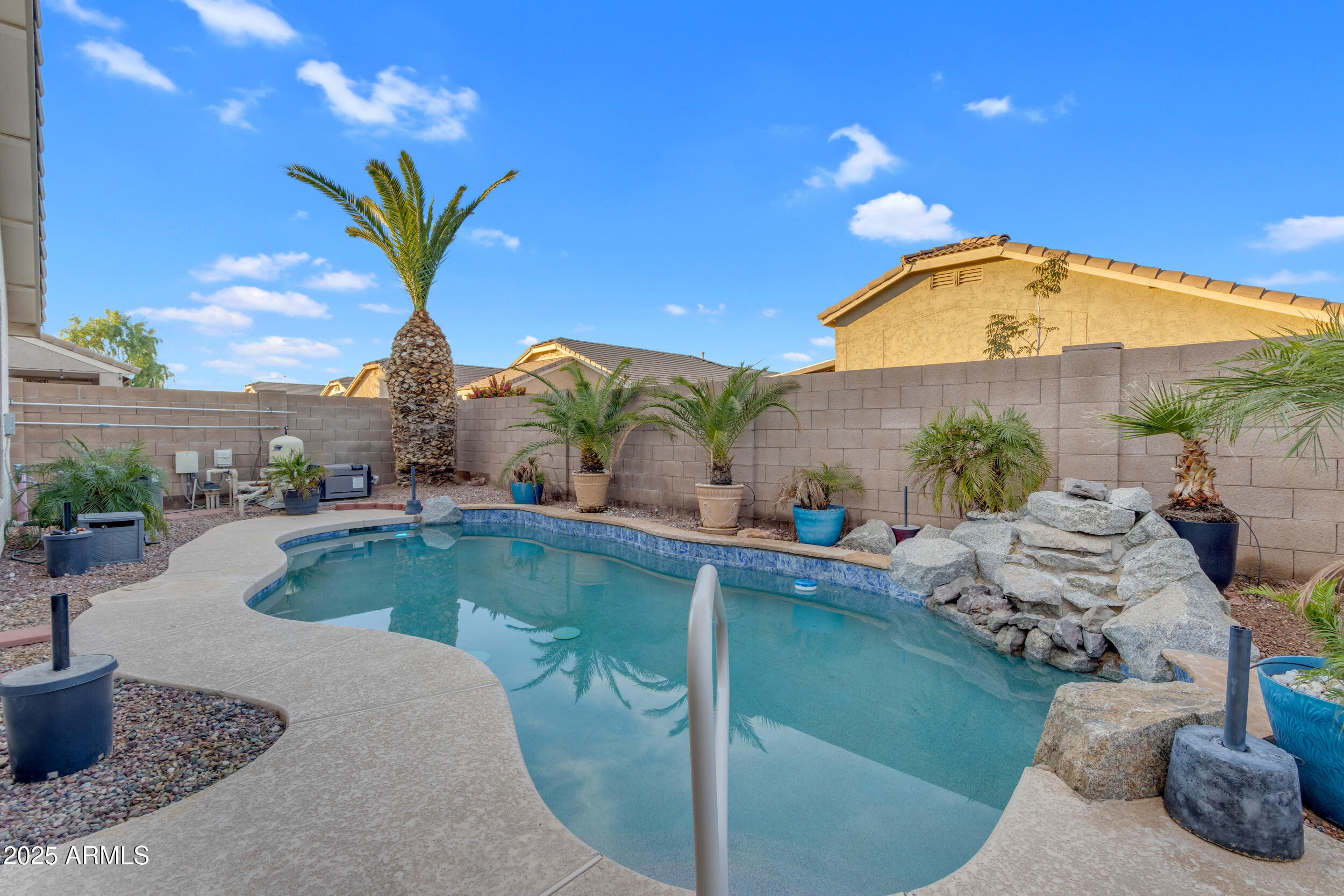 13438 West Redfield Road Surprise, AZ 85379 - Photo 64 of 75 a view of a swimming pool with a table and chairs