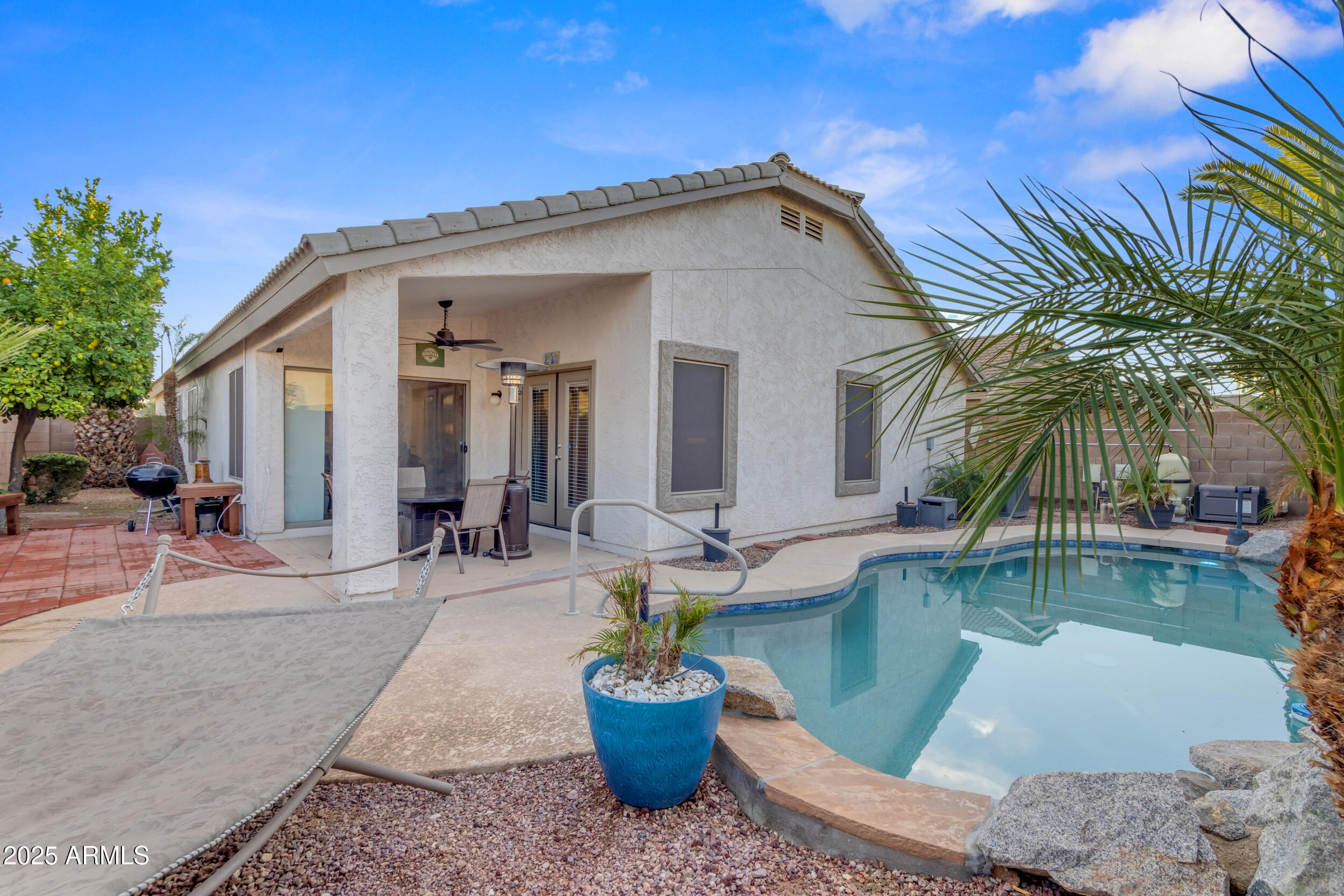 13438 West Redfield Road Surprise, AZ 85379 - Photo 65 of 75 a view of a house with swimming pool and sitting area