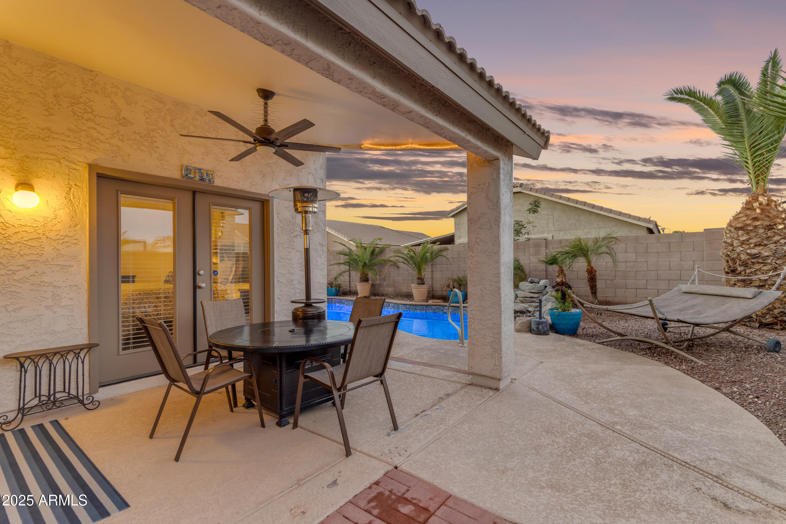 13438 West Redfield Road Surprise, AZ 85379 - Photo 70 of 75 a view of a patio with a table and chairs and floor to ceiling window
