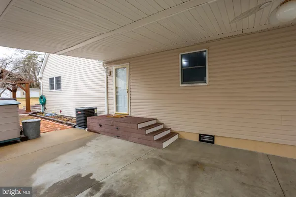 a backyard of a house with barbeque oven table and chairs