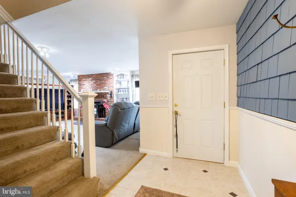a living room with furniture and stairs