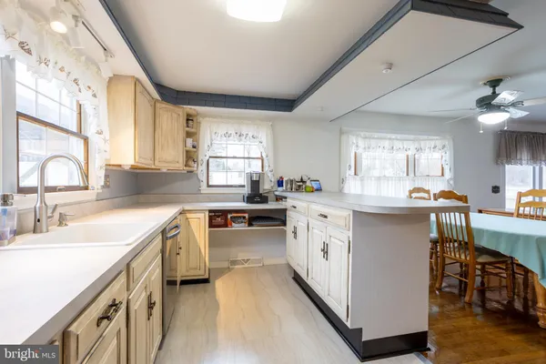 a kitchen with a refrigerator and a sink