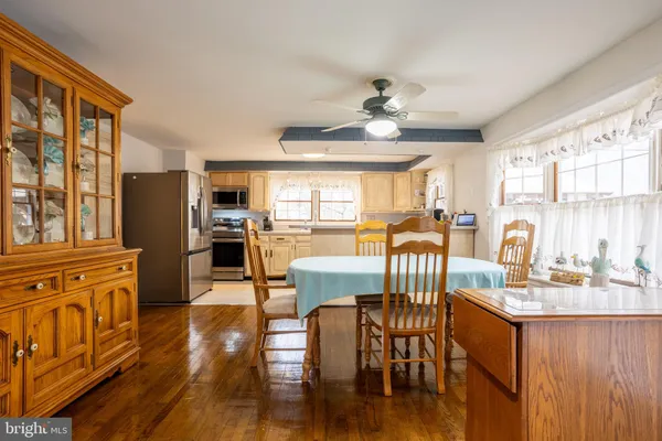 a view of a dining room with furniture window and wooden floor