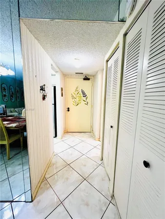 a view of a hallway with entryway door