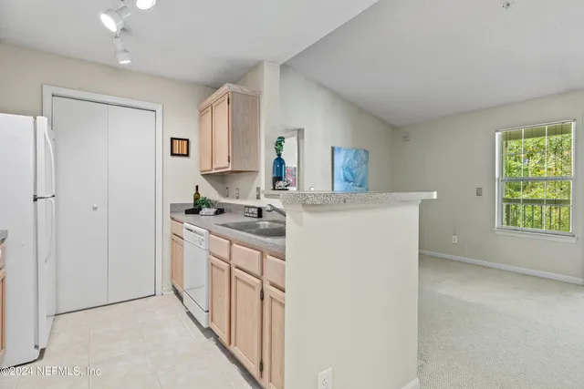 a spacious bedroom with a bed and a painting on the wall