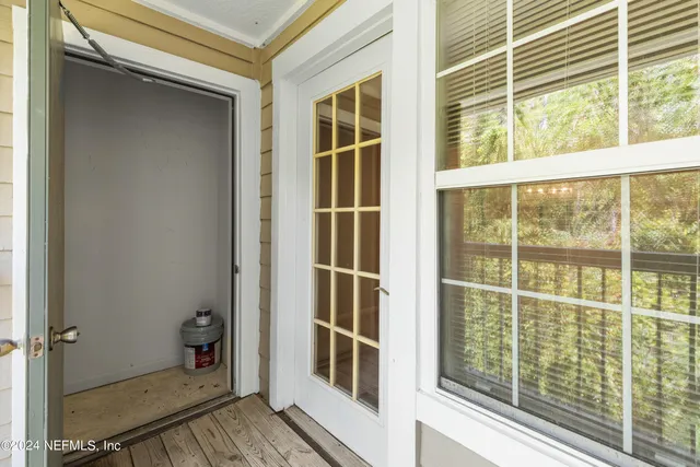 a view of a kitchen with refrigerator and window
