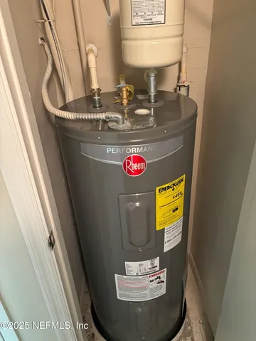 a kitchen with stainless steel appliances granite countertop white cabinets a table and chairs