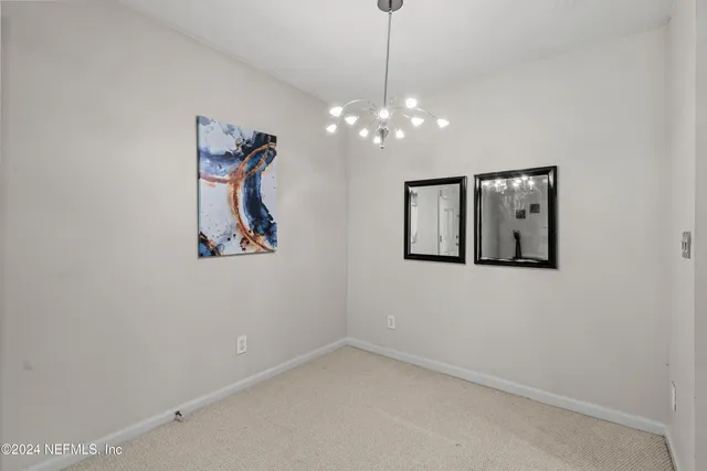 an aerial view of a house with a yard and trees