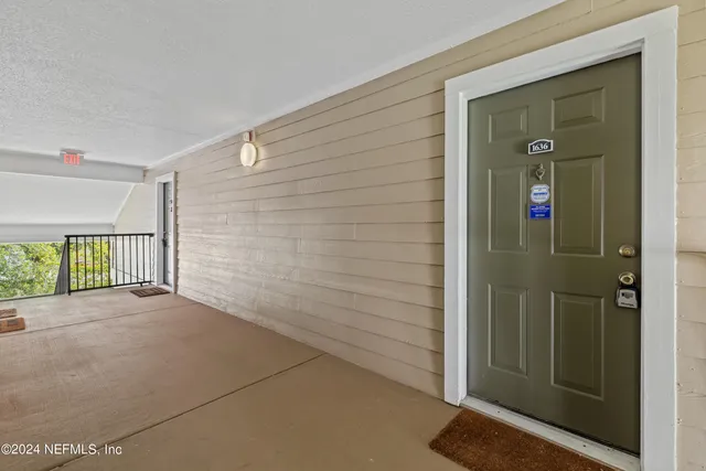 a living room with furniture and a dining table with kitchen view