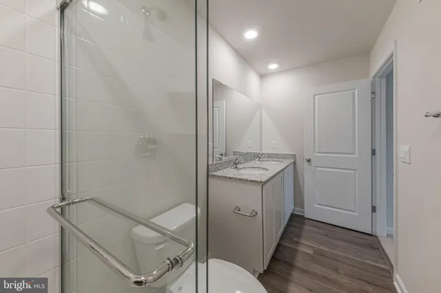 a bathroom with a sink a toilet and vanity