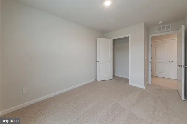 an empty room with closet area