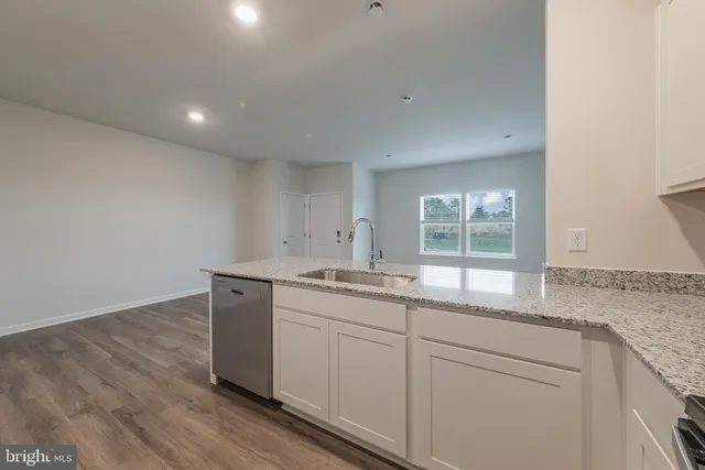 a kitchen with sink and cabinets