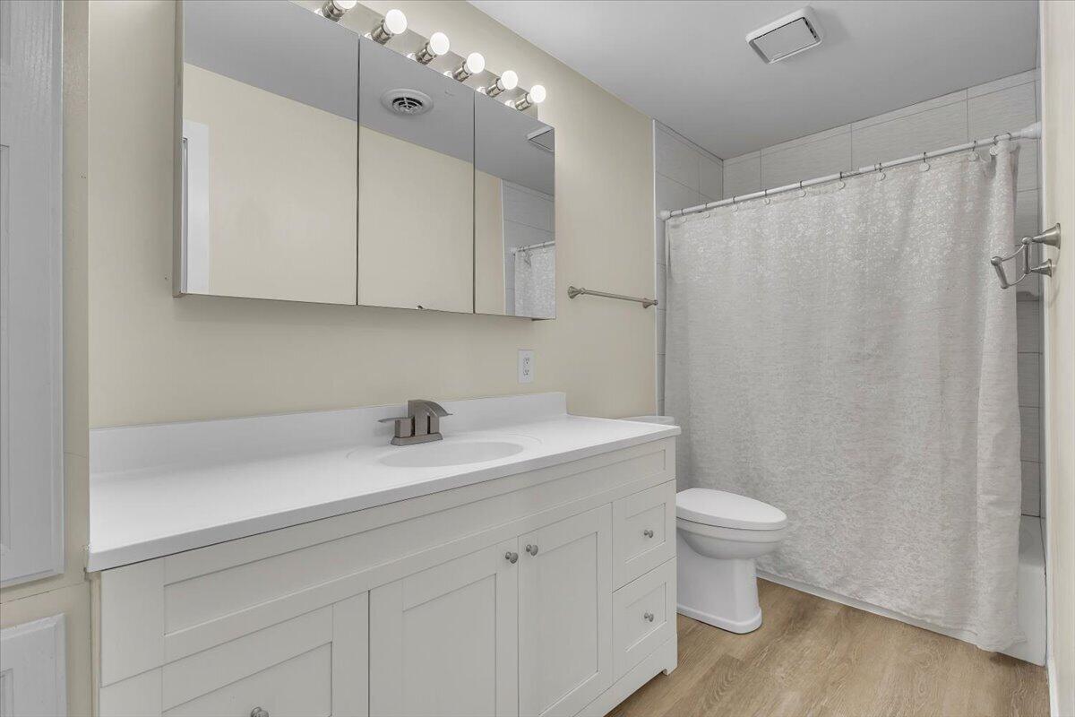 1444 Woodview Drive, Unit 7 Crown Point, IN 46307 - Photo 13 of 15 a bathroom with a sink a toilet and a mirror