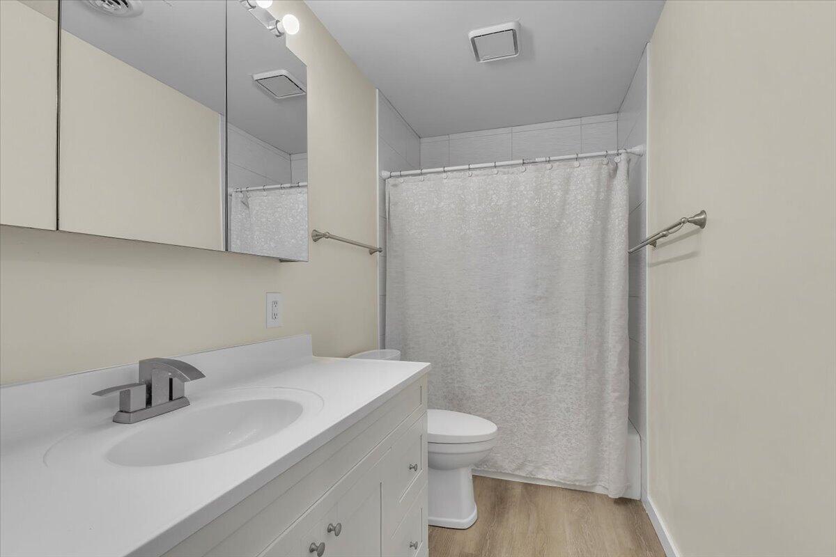 1444 Woodview Drive, Unit 7 Crown Point, IN 46307 - Photo 14 of 15 a bathroom with a sink toilet and vanity