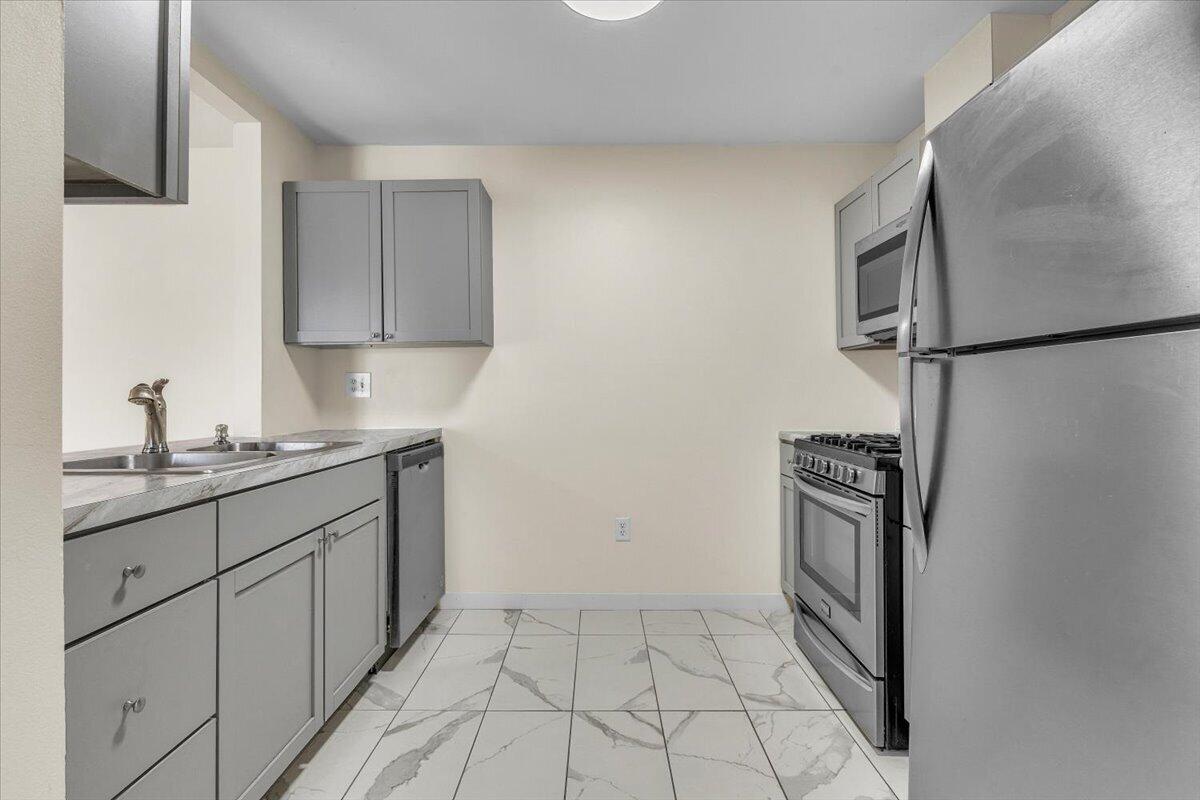 1444 Woodview Drive, Unit 7 Crown Point, IN 46307 - Photo 2 of 15 a kitchen with stainless steel appliances granite countertop a refrigerator and a sink